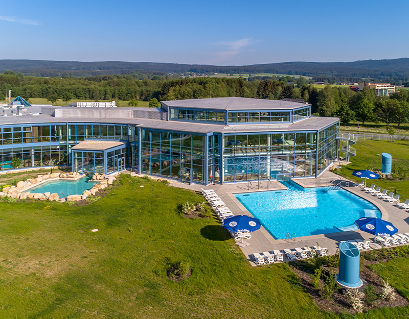 Außenansicht der Siebenquell Therme Bad Weißenstadt mit Thermalbecken und Liegewiesen im Fichtelgebirge.